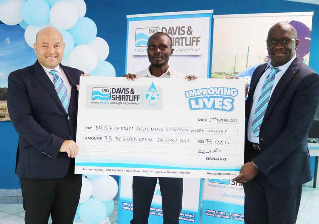 Eugene Omoke winner of the 75th anniversary competition being awarded by Managing Director Edward Davis, and General Manager David Bolo
